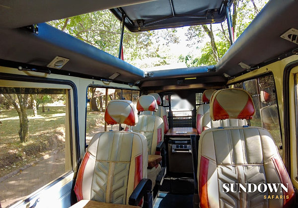 Safari vehicle interior with leather seats and the pop up roof open