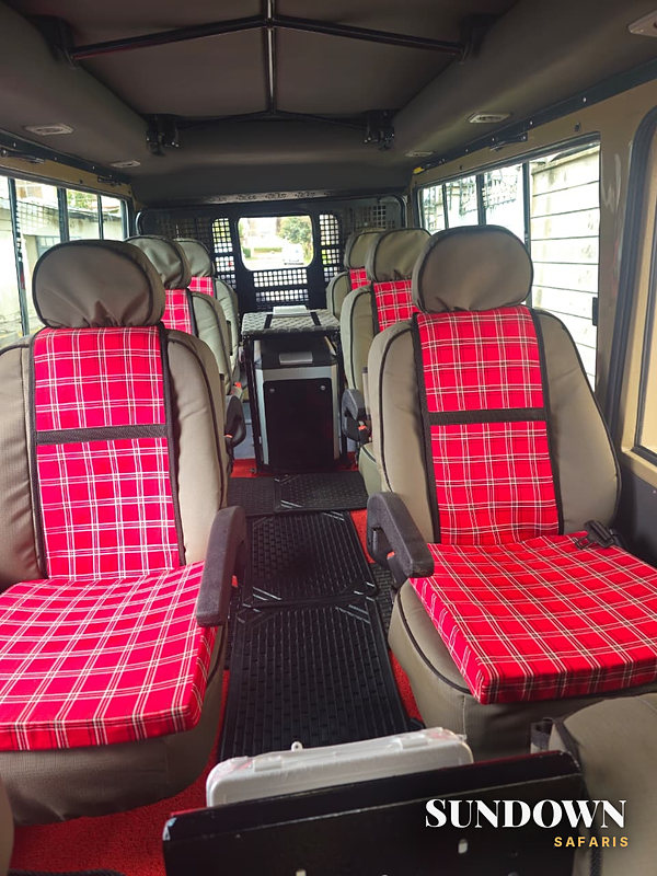 Safari vehicle interior with Maasai shuka seat covers and a fridge