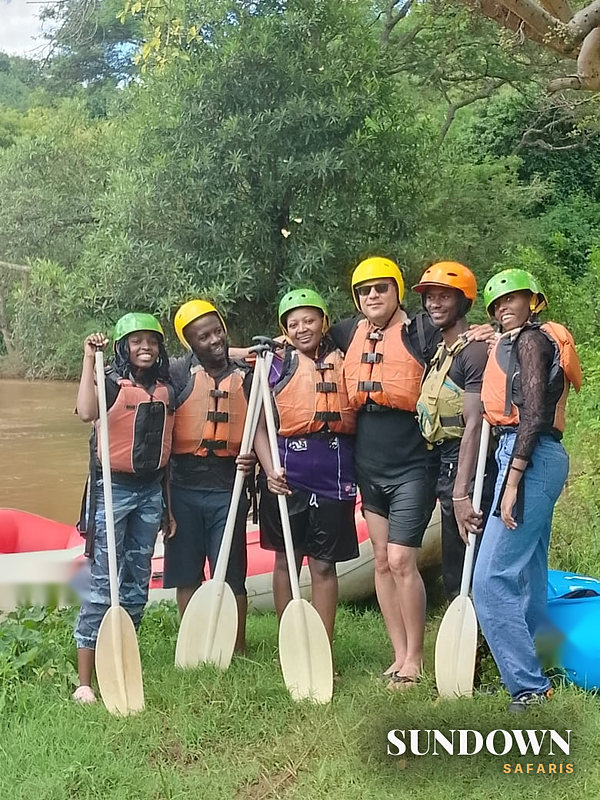A Sundown group in helmets and life jackets before rafting